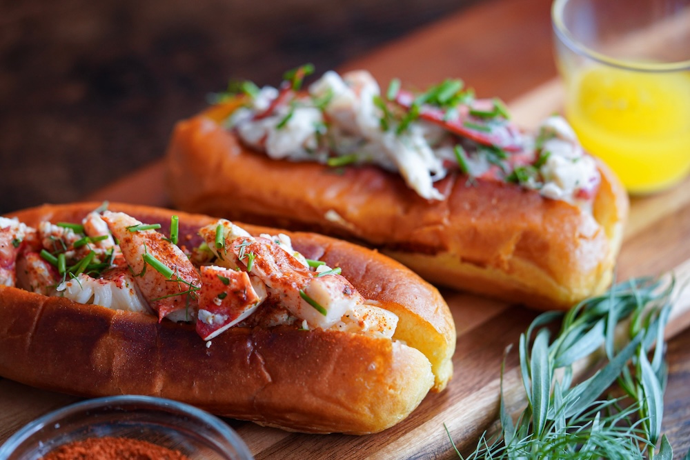 A close up of two lobster rolls.